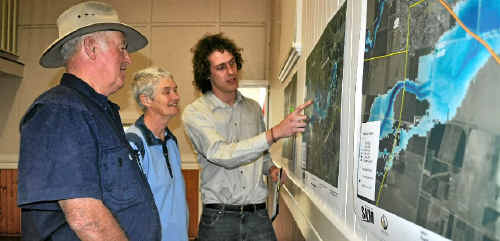 Allora homeowners Tom and Kaye Mullins are shown the flood maps by SKM representative David Berry on Saturday. Allora homeowners Tom and Kaye Mullins are shown the flood maps by SKM representative David Berry on Saturday.